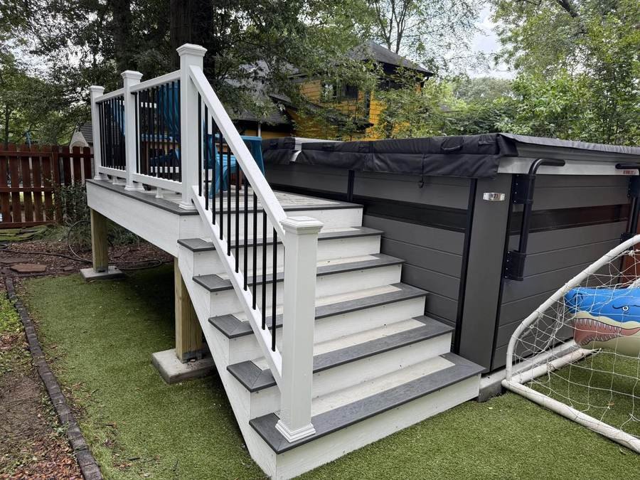 Composite deck and stairs wrapped around a swim spa