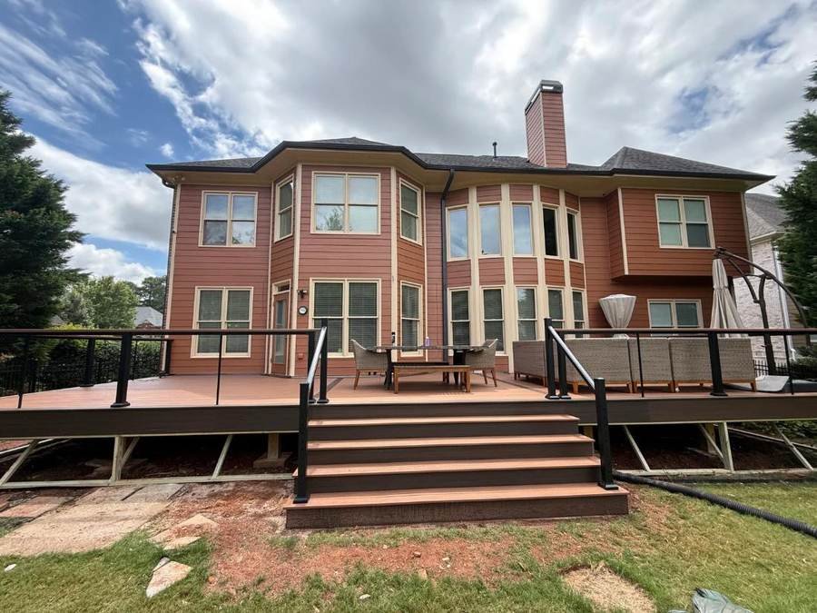 New two-story deck with stairs on a brick home